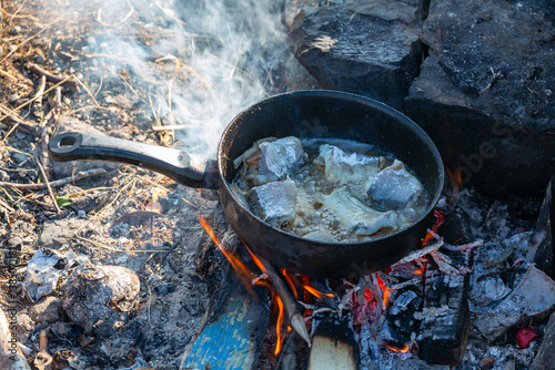 Obraz na płótnie Fish is fried in a skillet on the fire w salonie