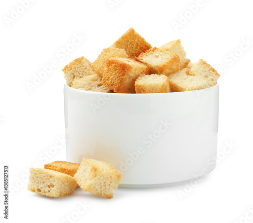 Delicious crispy croutons in bowl isolated on white