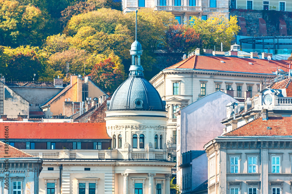 Budapest urban landscape, with buildings of varying heights and architectural details. Look at the architectural dome of the building in Budapest