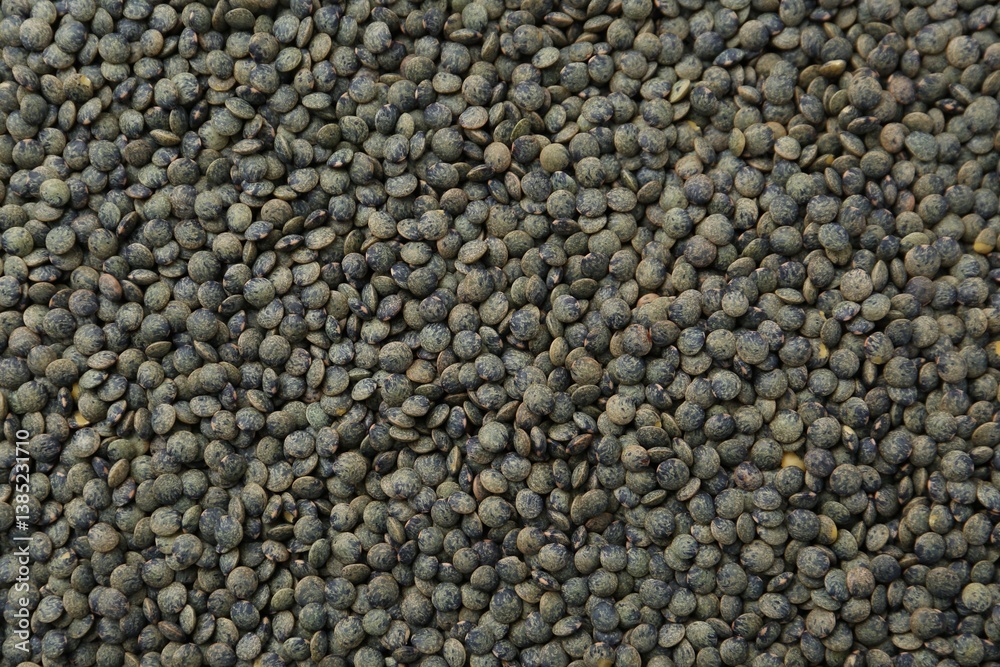 Raw green lentils as background, closeup view