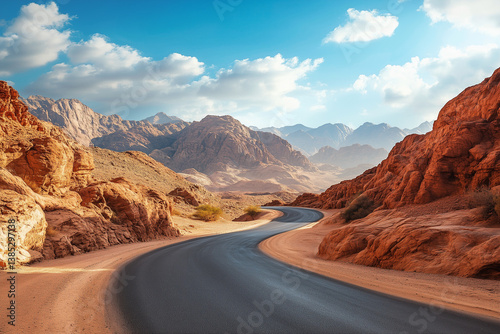 Empty road winding through desert landscape reflected in stock photo