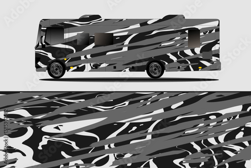Stylishly designed RV featuring an abstract black and white pattern, parked on a clean surface