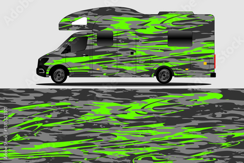 A vibrant, green and gray patterned camper van parked on a textured surface, showcasing its unique design