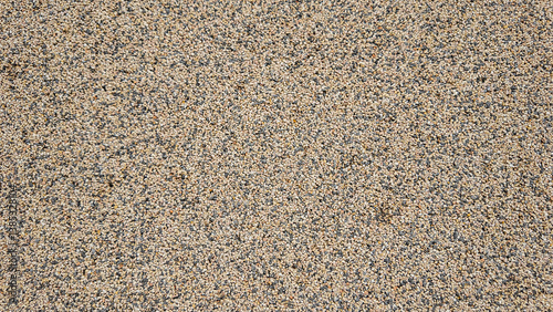 Exposed aggregate concrete creates textured surface background