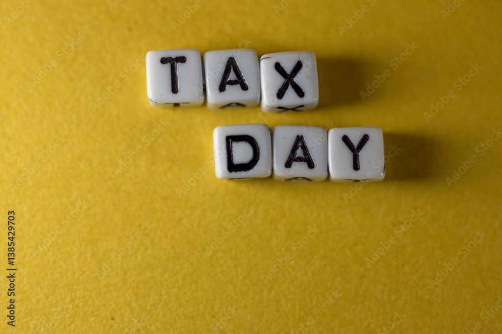 TAX DAY spelled out on yellow background TAX DAY spelled out on yellow background