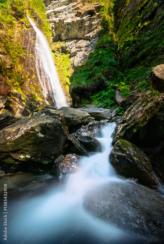Fototapeta premium waterfall in the alps with cascade river flow in front long exposure