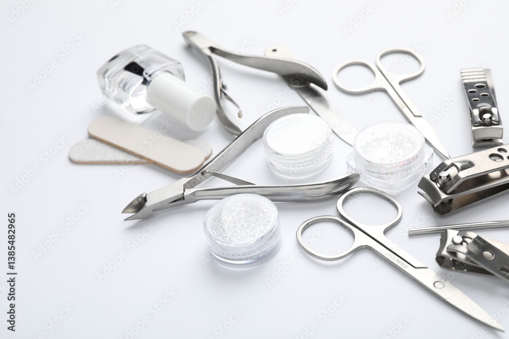 Set of different manicure tools on white background, closeup