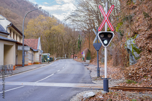 A railway signal light glowing white, indicating clear passage for drivers at a railway crossing.