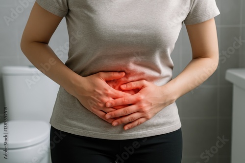 Woman suffering from strong abdominal pain in the bathroom