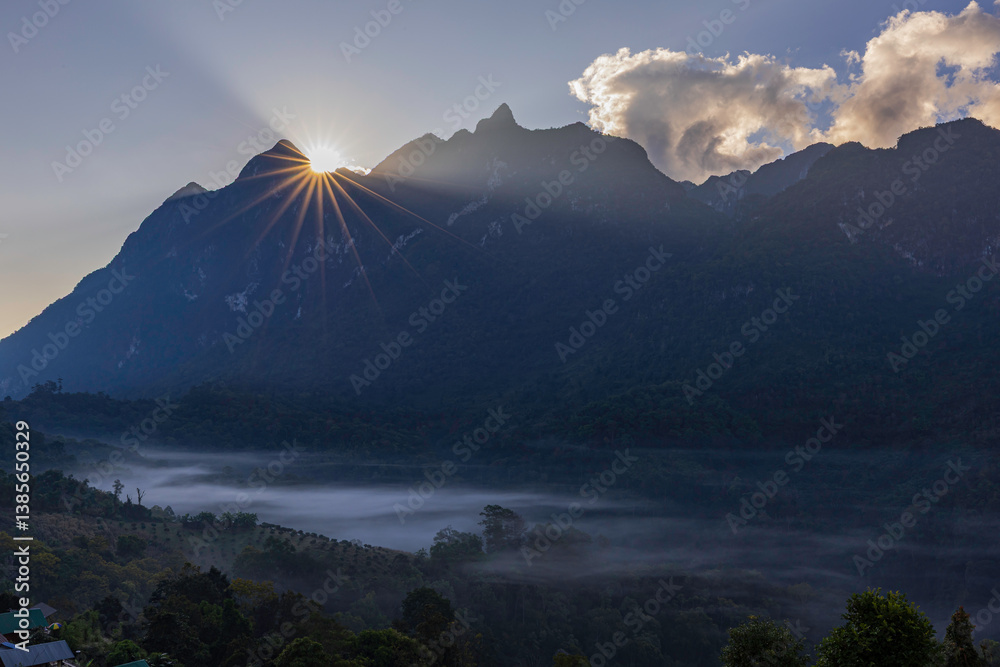 Doi Luang Chiang Dao mountain at dawn with with blue tone sunrise sky and silhouette valley shadow in Chiang Mai