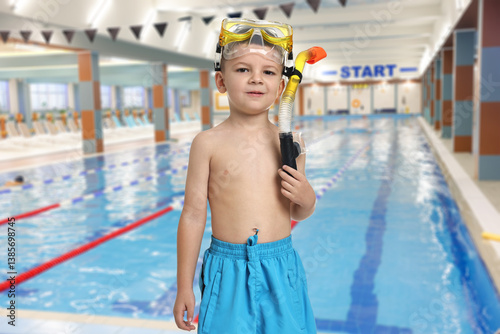 Obraz na płótnie Cute little boy in trunks with snorkeling equipment at indoor swimming pool w salonie