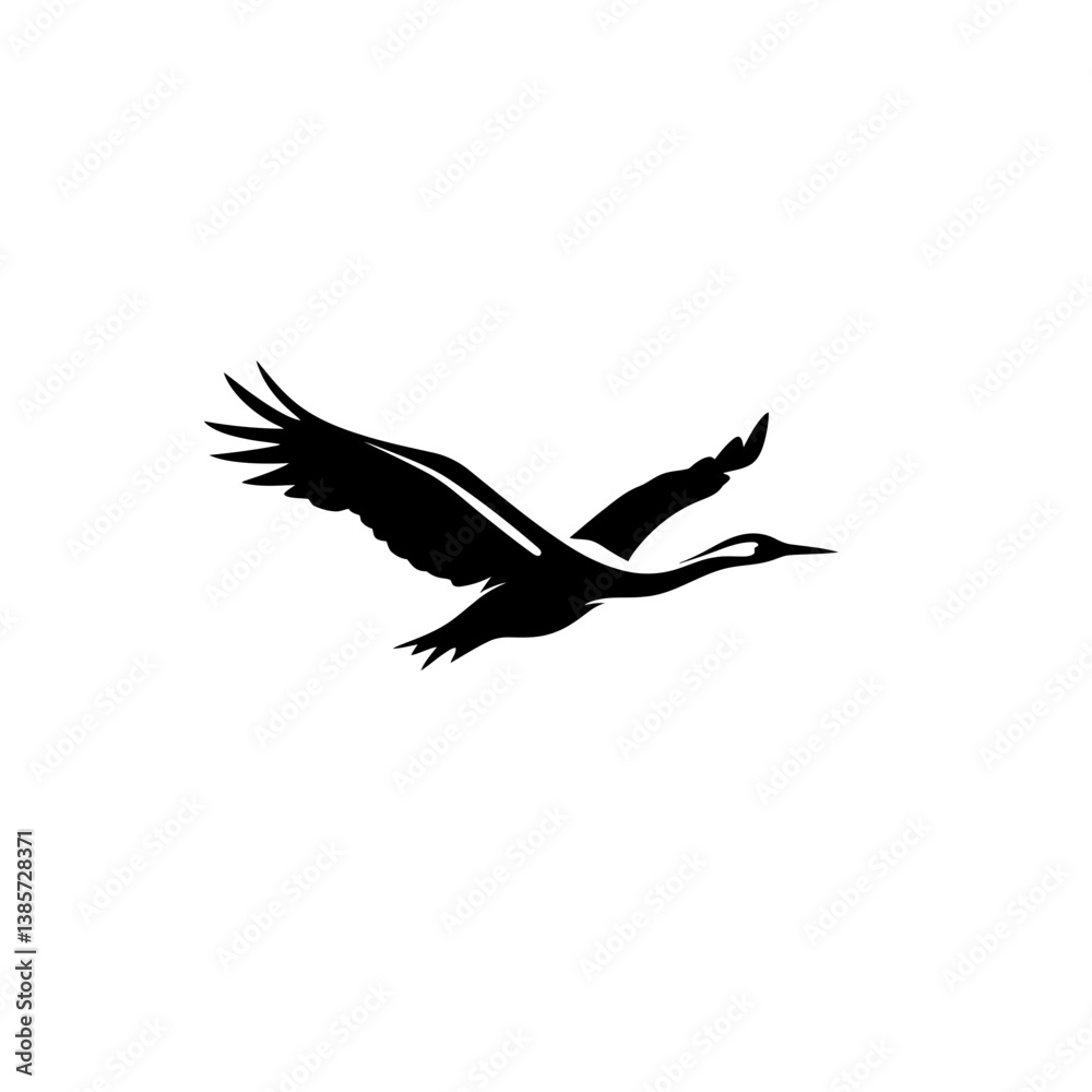 Obraz premium Silhouette Crane Soaring: A graceful crane in mid-flight, its wings elegantly outstretched against the backdrop of a clear sky, symbolizing freedom and aspiration. 