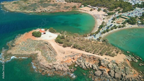 Drone shot of small bay, clear ocean and sandy beach in Crete