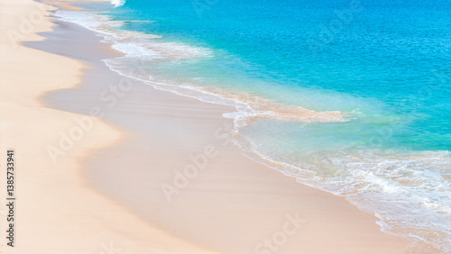 Fototapeta Naklejka Na Ścianę i Meble -  Aerial view of tranquil beach with turquoise sea and clean white shore. summer background and summer holiday concept.