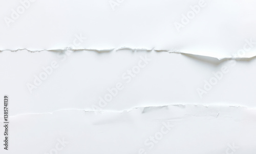 close up view of white paper background featuring torn edges, creating textured and layered appearance that adds depth and interest to composition