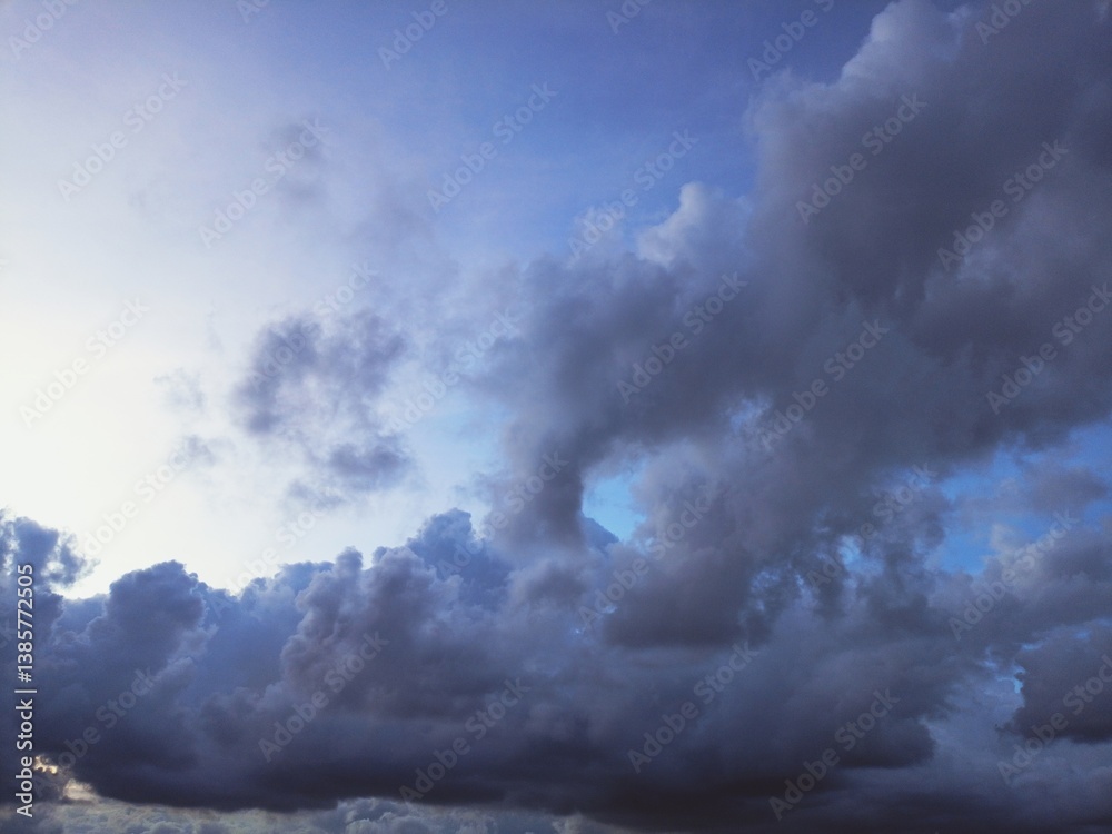 Obraz premium Dramatic Sky with Dark Clouds and Subtle Hints of Blue Horizon