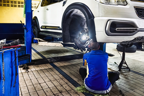 Car CV Axles replacement on front wheel drive car. Installation of wheel hub in car. Car mechanic or serviceman checking disc brake. Disc brake on car in process of new tire replacement. Car service