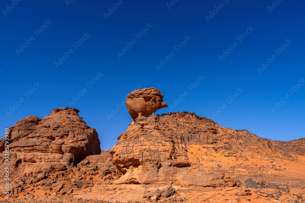 Tadrart Rouge, meaning Red Mountain, a mountain range in southeastern Algeria, part of the Algerian Desert providing massive dunes and rock formations, here the hedgehog. Tadrart Rouge, meaning Red Mountain, a mountain range in southeastern Algeria, part of the Algerian Desert providing massive dunes and rock formations, here the hedgehog.