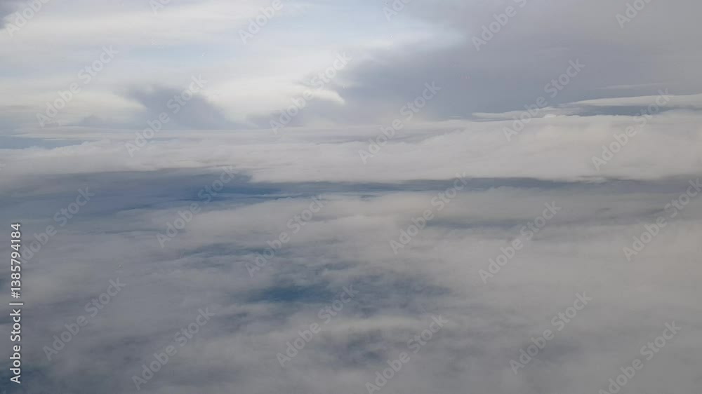 Overcast sky filled with fluffy, grey clouds. A serene and calming atmospheric view from above. Overcast sky filled with fluffy, grey clouds. A serene and calming atmospheric view from above.