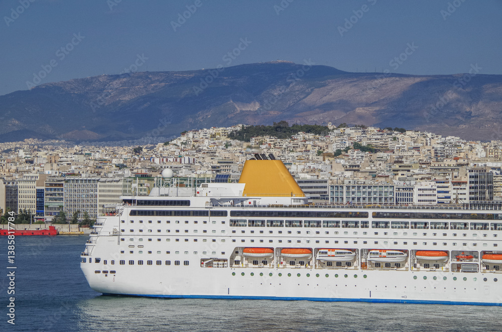 Partial view of stern of classic cruiseship cruise ship liner Neo Riviera in Piraeus Athens, Greece port with city skyline in background