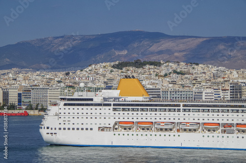 Obraz na płótnie Partial view of stern of classic cruiseship cruise ship liner Neo Riviera in Piraeus Athens, Greece port with city skyline in background w salonie