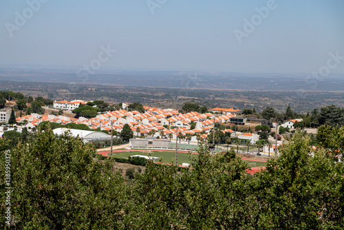 Panoramic summer view of the modern residential area and sports facilities in Castelo de Vide, Alentejo, Portugal, taken from a scenic viewpoint overlooking the surrounding countryside.