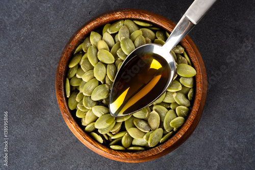 Obraz na płótnie Pumpkin seeds oil on wooden background w salonie