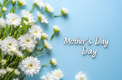 Minimalist Mother's Day concept flat lay with white flowers on blue