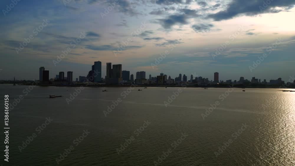 Cargo ship sailing near Phnom Penh skyline. Nice aerial view flight drone Cargo ship sailing near Phnom Penh skyline. Nice aerial view flight drone