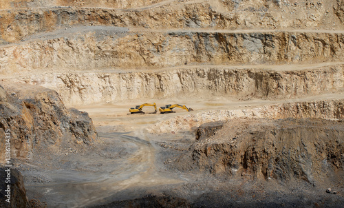 Behind the Mediterranean coastline, the slopes reveal detailed soil layers and formations, uncovered through quarry excavations, showcasing the region's geological 