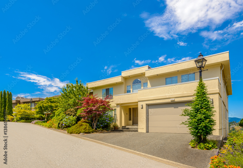 Fototapeta premium Garage door in luxury house with trees and nice landscape in Summer in Vancouver, Canada, North America. Day time on June 2024.