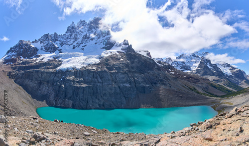 View point Mirador Cerro Castillo in national park in Chile. Cerro Castillo mountain and a lake with turquoise water. One of the best tourist destinations along Carretera Austral. Tourists in a trail.