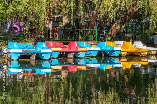 Obraz na płótnie Beautiful view of moored pedal boats and a tropical forest w salonie