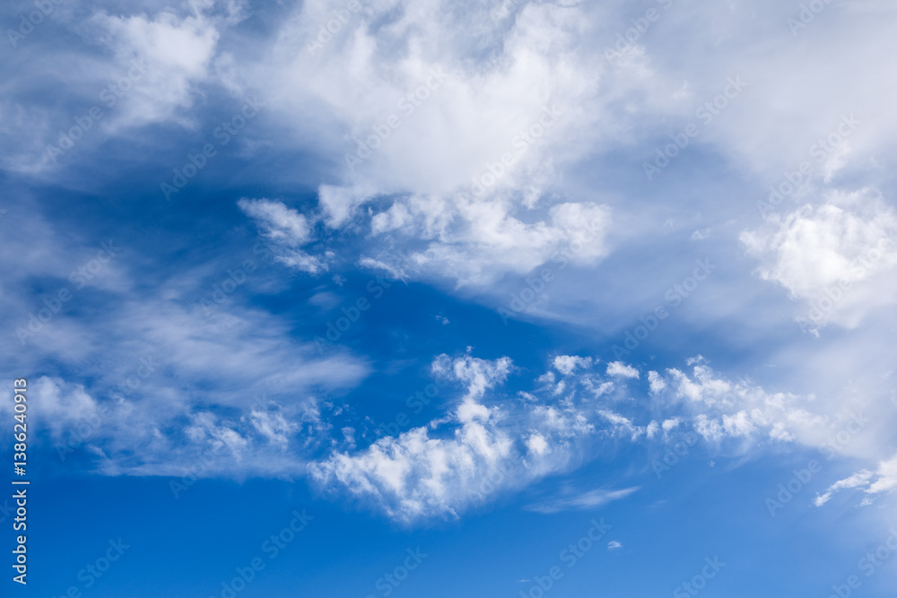 Fototapeta premium White Clouds Drifting Across a Vibrant Blue Sky