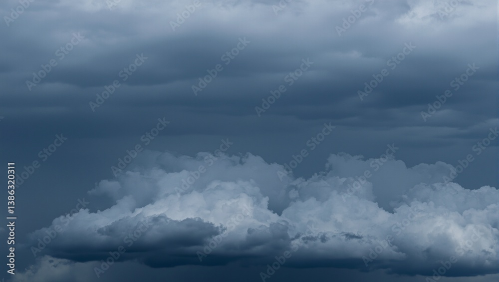 Obraz premium Dark storm clouds loom ominously swirling with deep gray tones in a dramatic display of approaching inclement weather