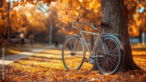 Vintage bicycle with a wicker basket parked under a tree with golden autumn leaves. Peaceful park setting by a calm river. Concept of fall season, cycling, and outdoor relaxation. Generative AI
