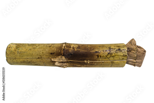 Khao Lam in bamboo tube isolated on white background, Clipping path. A traditional Southeast Asian dessert. Sweet sticky rice is cooked in bamboo tubes along with coconut milk, black beans.