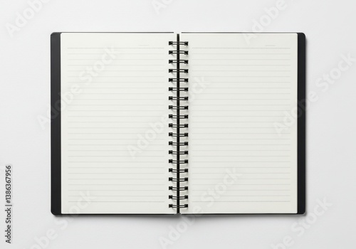 Open notebook with spiral binding and blank lined pages isolated on white background photo