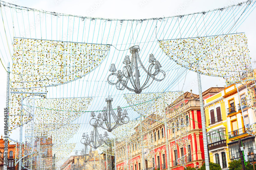 Vibrant charm of Seville with stunning street Christmas decorations that illuminate the historic architecture. Captivating scene captures the essence of festive celebrations in a lively urban setting