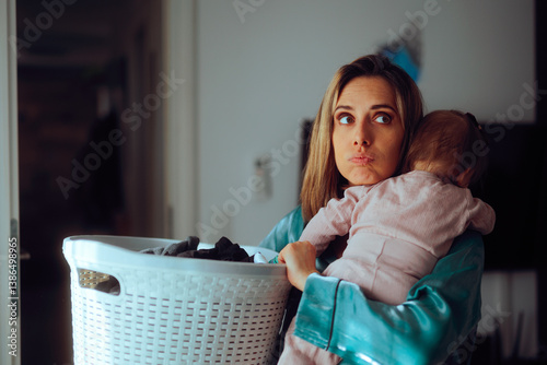 Mom Holds Baby and Laundry Basket Feeling Overwhelmed by Housework. Unhappy mother feeling tired and desperate for help with home chores 
