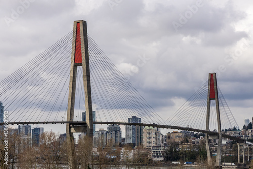 Skytrain Bridge Over River in New Westminster, Vancouver, BC, Under Cloudy Sky photo