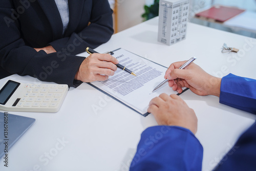 Tablou pe pânză Asian landlord, realtor man pointing on paper for sign signature contract with t