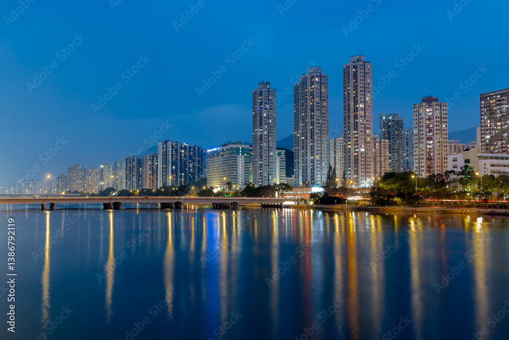 Obraz premium A night view of Sha Tin Wai and City One of Sha Tin District from the bank of The Shing Mun River. Hong Kong.