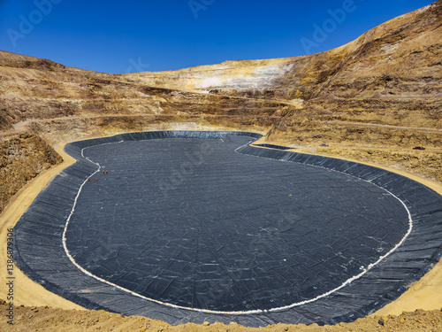 Process of constructing water pools with geosynthetic materials at the bottom of an open-pit mine photo