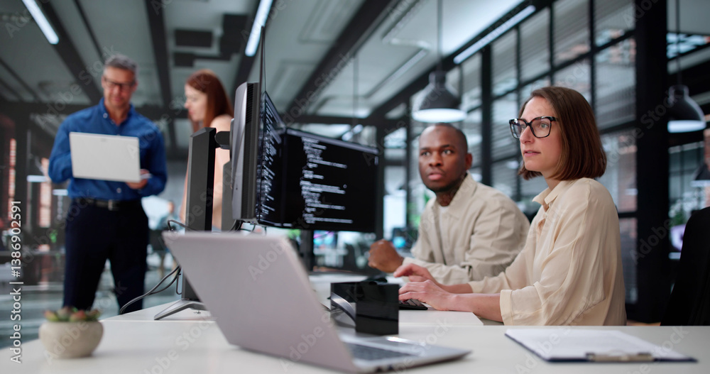 Young African American Woman Coding Software On Computer In Office
