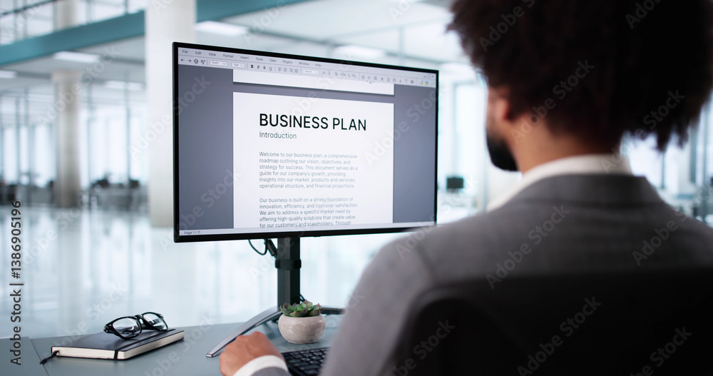 Man Using Computer To Manage Online Business Plan