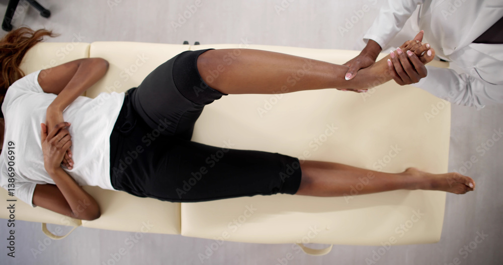 Professional African-American Physiotherapist Provides Therapeutic Exercise