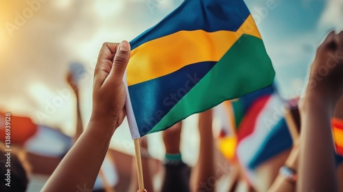 Patriotic fervor, Close-up view of a Gabonese flag amidst jubilant crowd