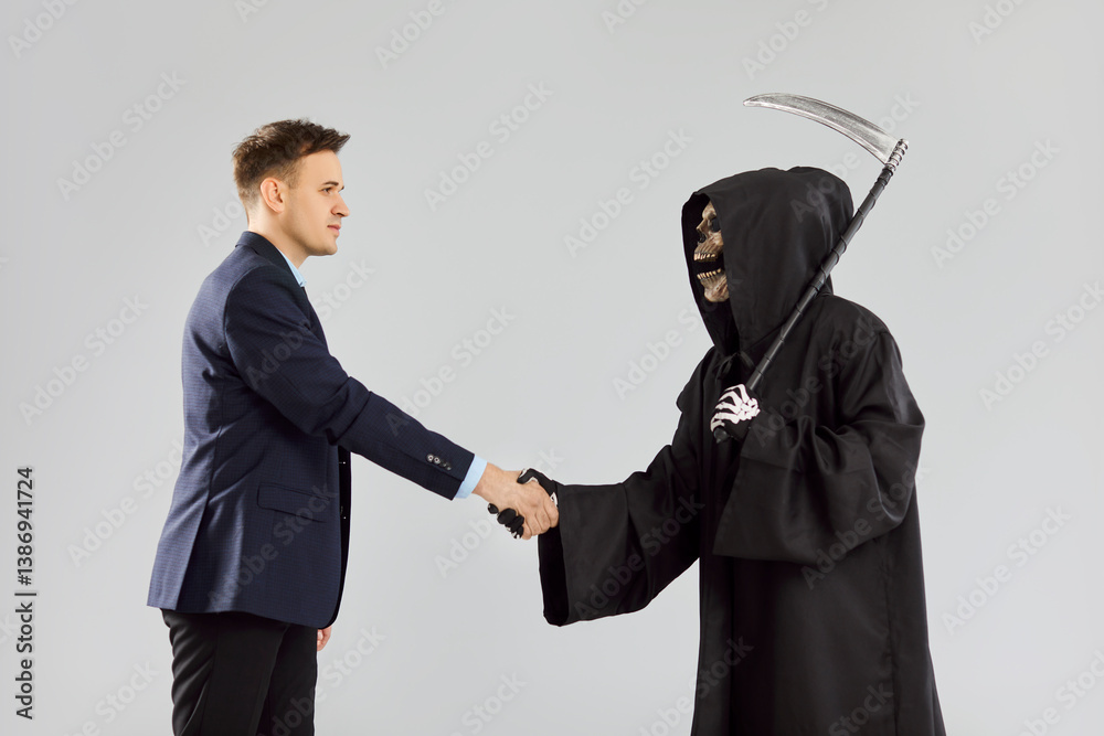 Grim reaper is shaking hands with a businessman on a grey background, signing a contract to sell his soul. This devilish image highlights the sinister agreement and the presence of death.