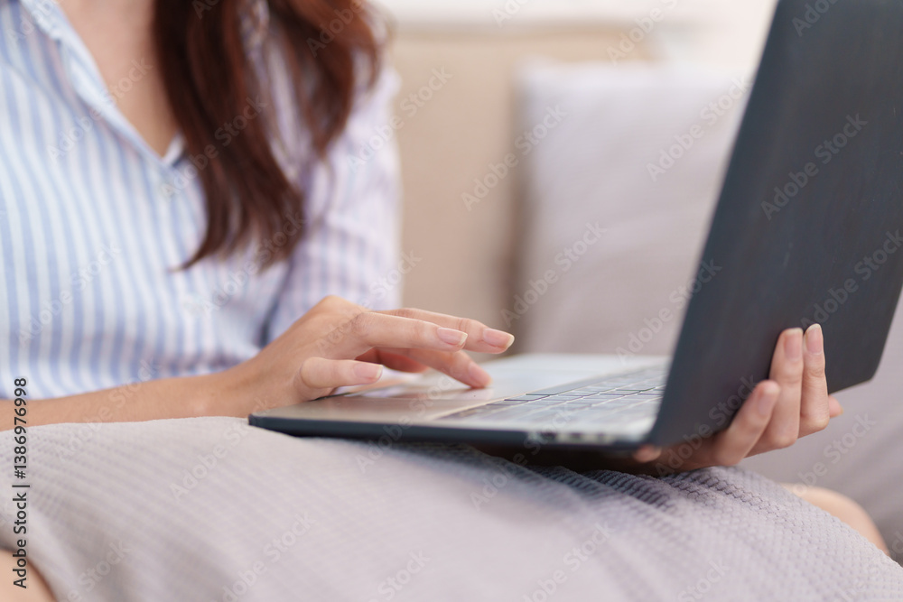 Laptop Connection: A close-up view of a woman effortlessly working on her laptop, highlighting the focus and ease of modern technology use. Laptop Connection: A close-up view of a woman effortlessly working on her laptop, highlighting the focus and ease of modern technology use.